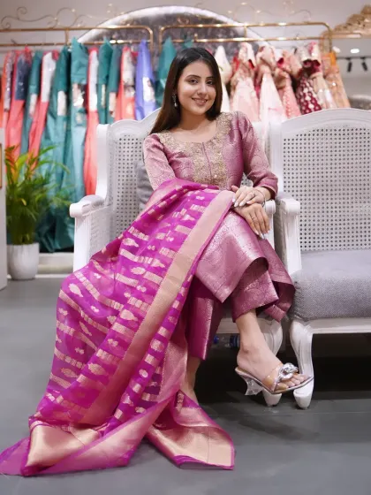 This outfit exudes class, celebrates culture, and radiates charm. A beautiful mauve suit with a contrasting magenta Banarasi dupatta.