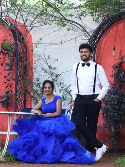 This couple chose a vibrant royal blue ball gown and a classic suit with a bow tie for their pre-wedding shoot, creating a look that is both fun and formal.