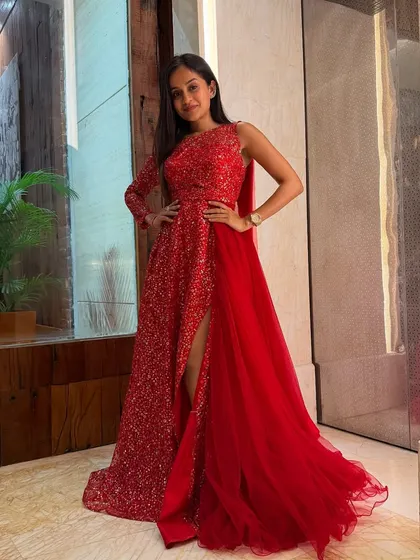 All set and ready for the show! I believe in looking the part, whether it's a glamorous sangeet or a formal reception. This stunning red gown had me feeling confident and ready to bring the energy.