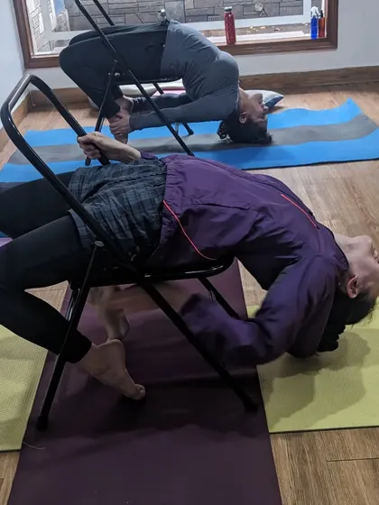 A little post-Holi relaxation. Students enjoying a deep backbend over a chair, a perfect way to release and restore the body and mind.