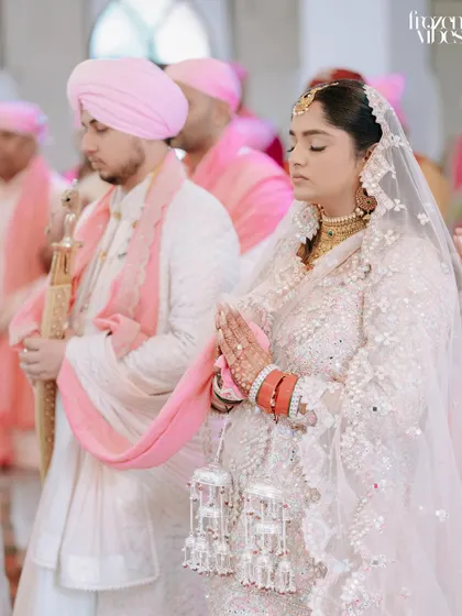 A moment of prayer during the Sikh wedding ceremony. I capture these solemn and spiritual moments with reverence and a focus on the couple's devotion.