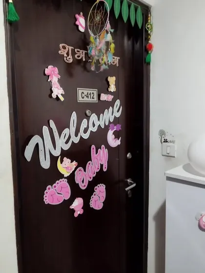 A close-up of the 'Welcome Baby' door decoration, making the homecoming special.