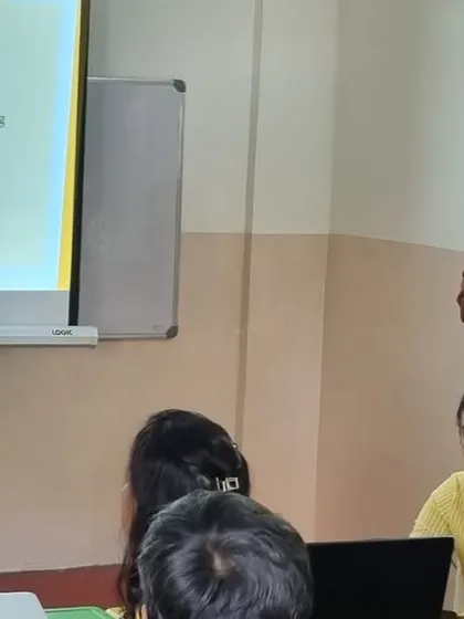 I am seen here presenting our curriculum and philosophy to new parents during an orientation session. We believe in building a strong partnership with parents from day one.