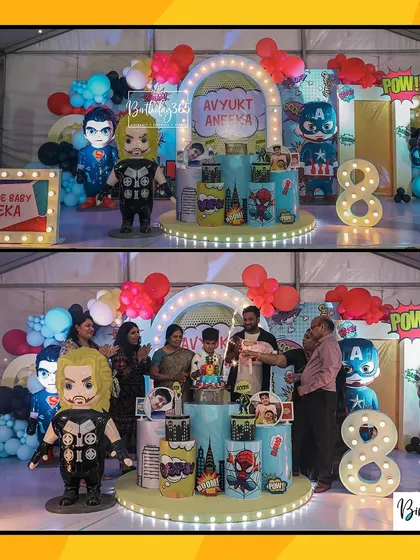 The whole family joins in for a photo at this awesome superhero party. The setup includes fun, chibi-style character props of Thor, Captain America, and the Hulk.