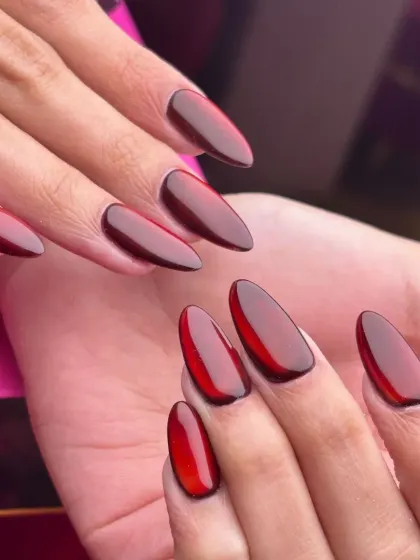 These "jelly" nails have a translucent, glass-like finish in a deep ruby red. The dark outline enhances the dimensional effect, making them look like polished gemstones.