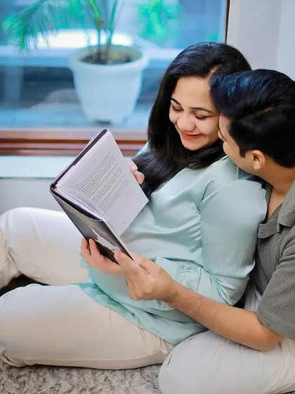 A cozy at-home session, capturing the couple reading together. These lifestyle shots tell a beautiful story about your life as you prepare for the baby.