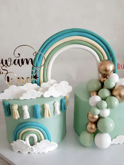 A lovely set of pastel green twin cakes for Divam's first birthday. The boho rainbow theme with tassels and a balloon garland created a cohesive and stylish look for the celebration. The flavors were rich chocolate and vanilla with mixed berries.