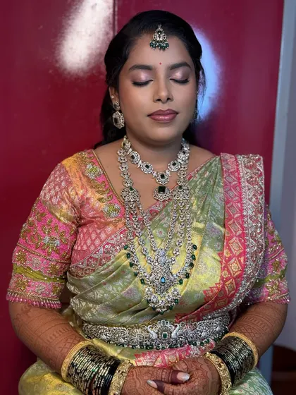 A close-up of Chaitra's reception eye makeup. The soft pink and silver shimmers on the lids make her eyes sparkle.