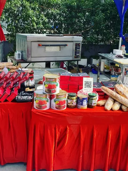 A full view of our live pizza counter at an outdoor event. We bring everything needed, including the oven, prep tables, ingredients, and serving supplies.