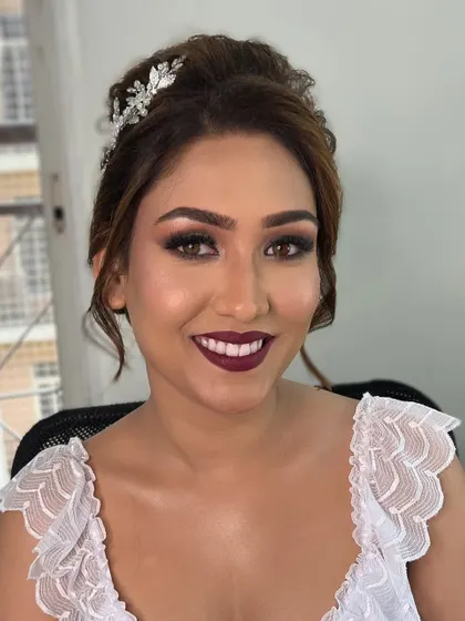 A happy smile from the bride, showcasing her complete look. The combination of bold lips and sparkling eyes creates a stunning effect.