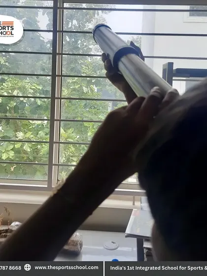 Students explore the properties of light using a telescope during a hands-on science lab activity.