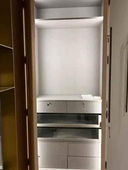 The interior of another bespoke wardrobe, featuring glass-fronted drawers and custom compartments. I can incorporate various accessories and lighting to make your storage both functional and beautiful.