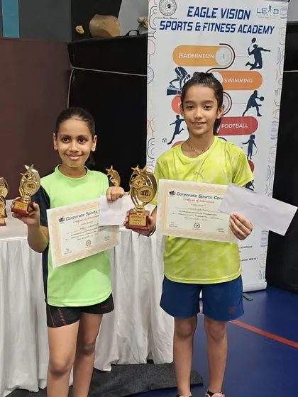 Two of our champions, Kashvi and Nitika, posing together with their collection of trophies from the Corporate Sports Connect Tournament. Their success inspires the entire academy.