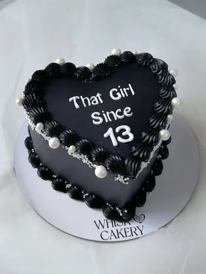 A bold black heart-shaped cake. This non-fondant cake is made with black ganache and decorated with pearls for a chic and edgy look.
