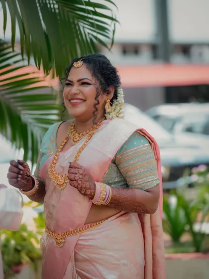A candid shot of the bride sharing a laugh during her engagement ceremony. This photo captures her natural beauty and the genuine happiness of the moment.