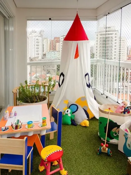 Balconies can be for kids too. I designed this safe and fun play area using soft artificial grass, a tent for imaginative play, and a child-sized table and chairs, giving the little ones their own special outdoor space.