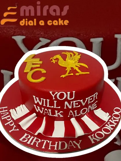 A cake for a die-hard Liverpool FC fan. The vibrant red design features the club's crest and the iconic anthem, "You Will Never Walk Alone," making it a powerful statement of loyalty.
