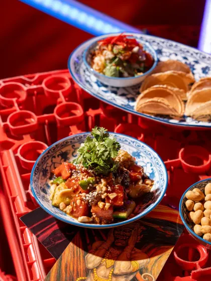 A close-up of a Thai-style salad at Banng Bar. The high-angle shot and use of red crates as a background element maintain the bar's edgy, street-food-inspired theme.