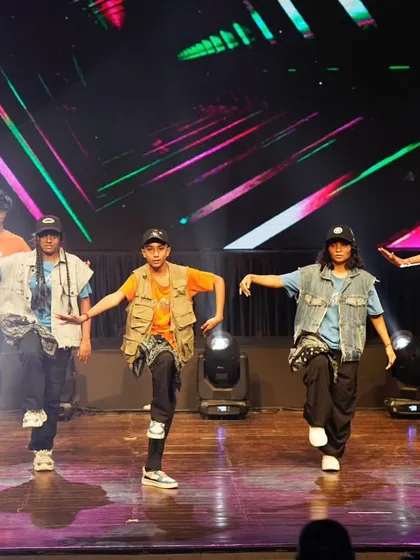 The team strikes a final, powerful pose. The mix of colorful background graphics and stage lighting made this hip hop act a visual treat.