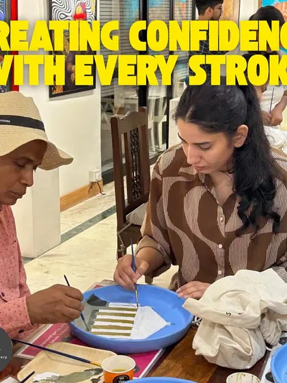 I help my students build confidence with every brushstroke. This image shows the supportive and collaborative atmosphere of my adult art classes.