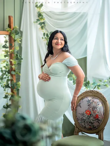 Using elegant studio furniture like this vintage chair adds a touch of sophistication to your maternity portraits.