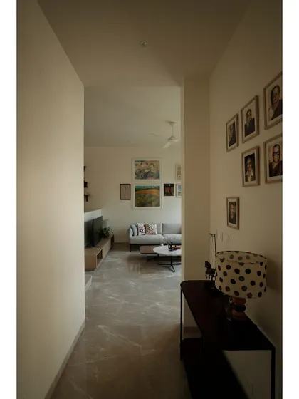 The same corridor view, showing how the passage frames the living space beyond.