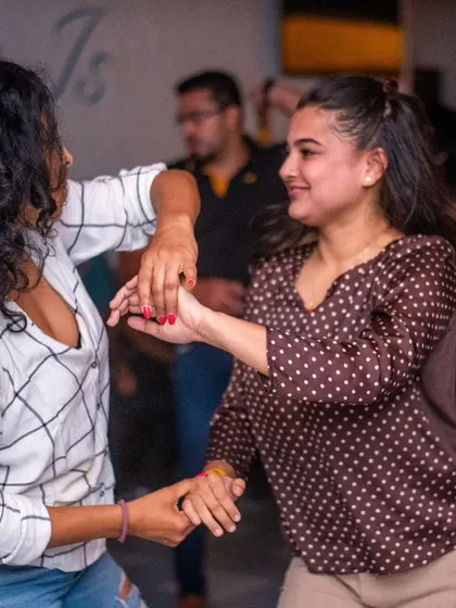 Two friends enjoying a dance together, moving in sync.