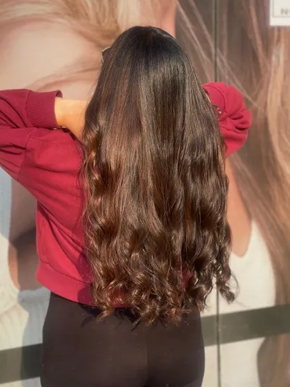 A duplicate image showcasing the beautiful, healthy curls on this client's long, dark hair.