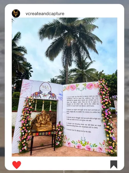 A unique wedding entrance designed as a giant open book displaying the couple's vows, with a Ganesha idol for blessings.