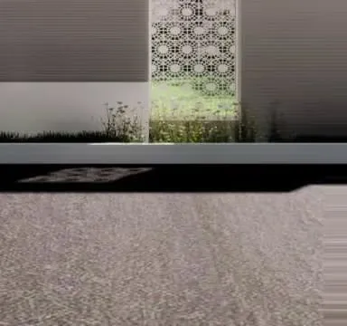 A close-up of a decorative 'jaali' screen used as a privacy and design element within the garden. This feature allows light and air to pass through while creating beautiful shadow patterns on the ground.