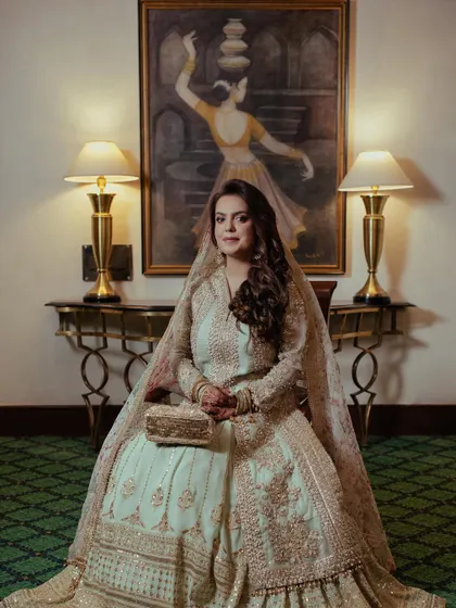 A solo portrait of the bride at her reception, looking poised and elegant in her beautiful pastel outfit.