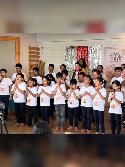 A group of children from our Bala Shivir stands together, ready to chant. This moment captures the discipline and unity fostered in our kids' programs.