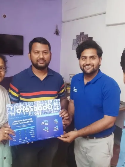 A family holds our "GoodZero" brochure, ready to enjoy zero electricity bills.