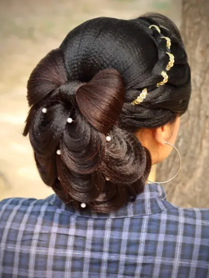 This peacock feathers bun with a bow is a creative and artistic hairstyle. My course encourages students to think outside the box and create unique designs.