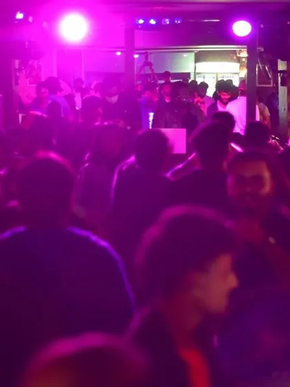 A purple-hued shot of a packed dance floor at a 'Gusto' event. The focus is always on creating an atmosphere where people can get lost in the music.
