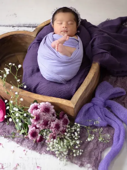 I just love the color purple. This two-day-old newborn was a delight, resting peacefully in a heart-shaped bowl surrounded by shades of lavender and violet.