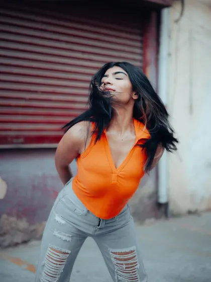 A candid shot with hair in motion. This dynamic portrait captures a sense of freedom and energy, adding life to a street style series.