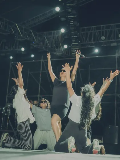 A powerful final pose during a rehearsal, with all dancers reaching for the sky. This is a moment of unity and focus before the big show.