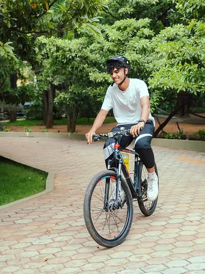 A guest enjoys a leisurely bike ride along our paved pathways, surrounded by lush trees. It's a peaceful way to stay active and explore the grounds.