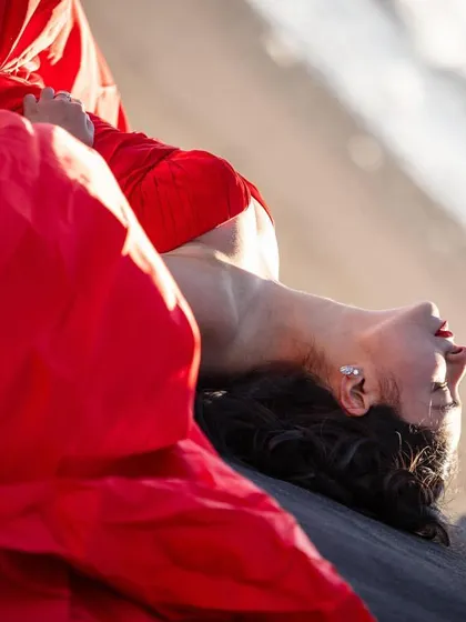 An artistic, abstract shot of Shree in her red gown. The focus on the color and fabric texture creates a powerful and memorable image.