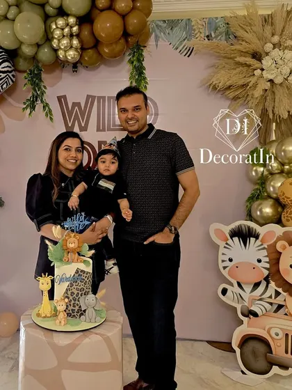 The family smiling brightly as they celebrate their little one turning one.