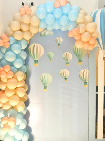 A close-up of the hot air balloon backdrop, with 3D paper balloons creating a sense of depth.