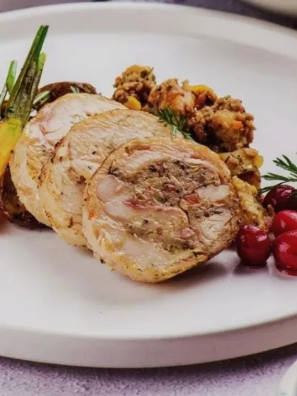 Sliced turkey roulade with stuffing and cranberries. A festive dish that brings the holiday spirit to the table.