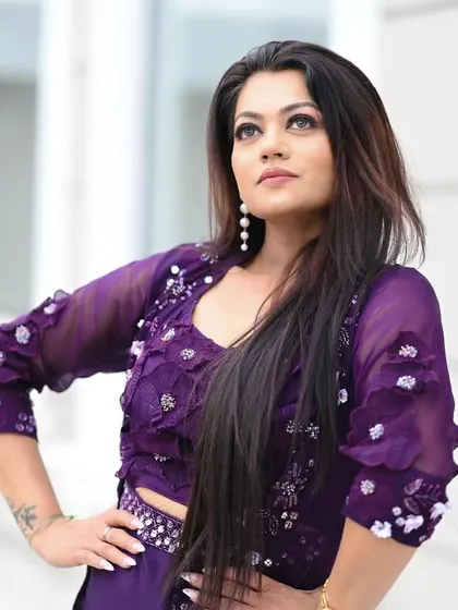 A powerful outdoor portrait of a model in a purple co-ord set, looking confident and stylish.