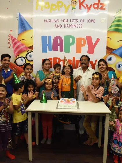 From small family gatherings to big birthday bashes with all their friends, we can host it all. This photo captures a wonderful celebration with the whole family joining in on the fun in our dedicated kids' party venue.