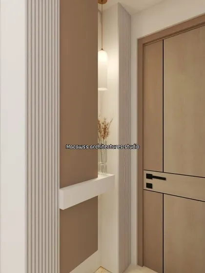 A detailed shot of a foyer area, showing the combination of a modern wooden door, fluted wall panels, and a minimalist pendant light. These small details are key to creating a cohesive design.