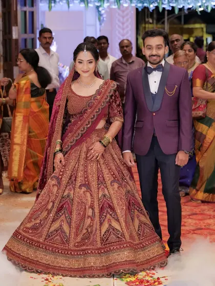 The couple making their entrance. The bride's makeup is radiant and she looks confident and happy.