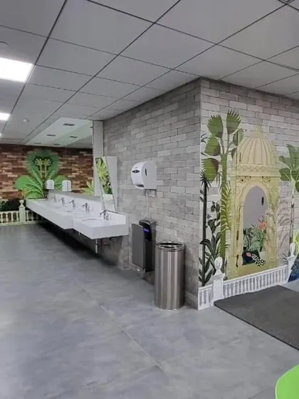 At the Providence healthcare company in Hyderabad, we transformed their large cafeteria with multiple murals. This one features a serene tropical Mughal theme, with peacocks and gazebos, creating a relaxing atmosphere.
