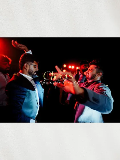 A high-energy, motion-blur shot of the men dancing at the cocktail party, capturing the fun and excitement of the night.