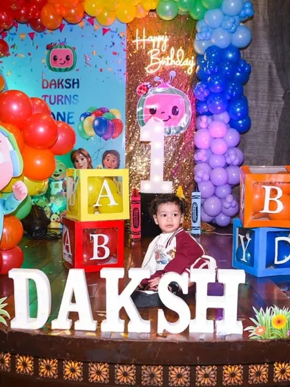 A great shot of the birthday boy, Daksh, with his name in lights at his colorful Cocomelon-themed first birthday party.